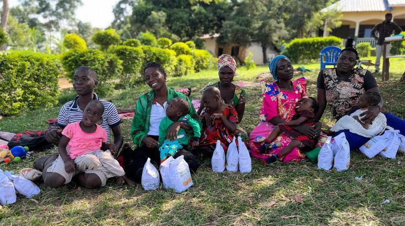 Uitdelen van voedzame pap aan gezinnen tijdens het project in Jinja